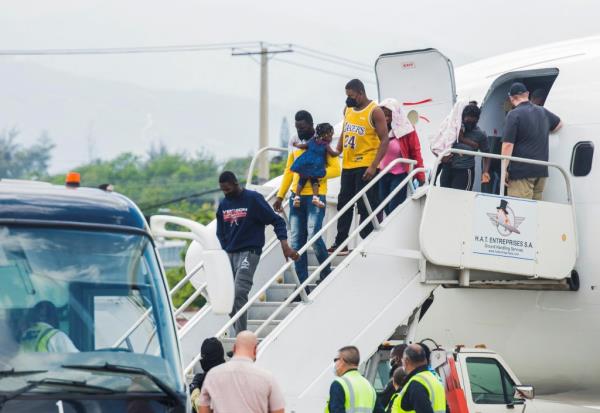 Haitian migrants get off a plane after U .S. authorities flew them out of a Texas border city on Sunday wher<em></em>e thousands of mostly Haitians had gathered under a bridge after crossing the Rio Grande river from Mexico, in Port-au-Prince, Haiti September 19, 2021.