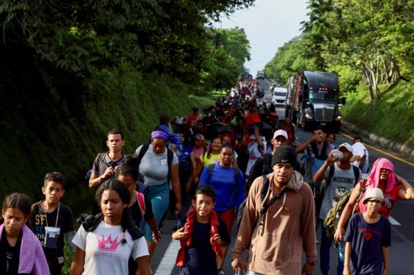 Migrants walk in a caravan toward the U.S. border, in Villa Comaltitlan, Mexico July 25, 2024.