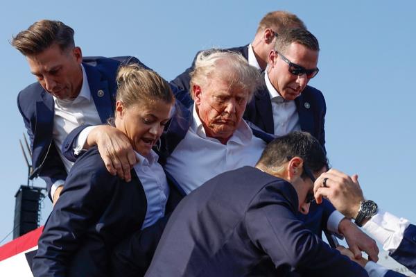  Republican presidential candidate former President Do<em></em>nald Trump is rushed offstage by U.S. Secret Service agents after being grazed by a bullet during a rally on July 13, 2024 in Butler, Pennsylvania. 