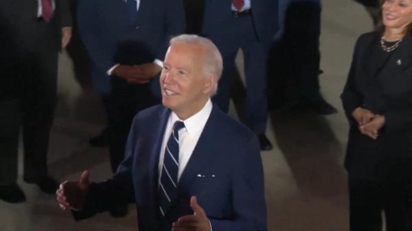 Biden had a sinister-looking smile on his face while telling reporters they were "stuck with him."