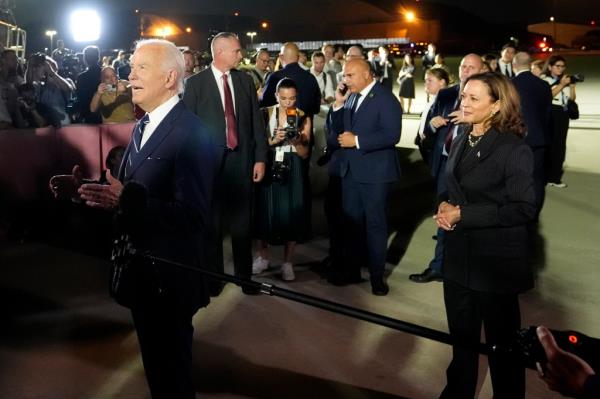 Biden, left, and Vice President Kamala Harris, right, speak with reporters after greeting reporter Evan Gershkovich, Alsu Kurmasheva and Paul Whelan at Andrews Air Force ba<em></em>se, Md.