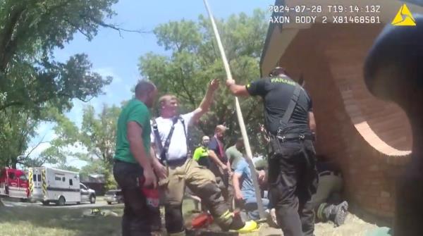 Rescuers using a pole.