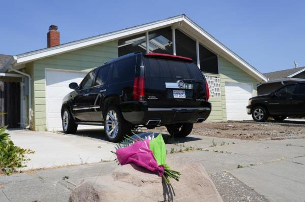 Flowers left at the house wher<em></em>e the massacre took place in Alameda.