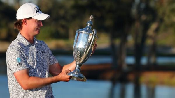 Maverick McNealy poses with the winner's trophy